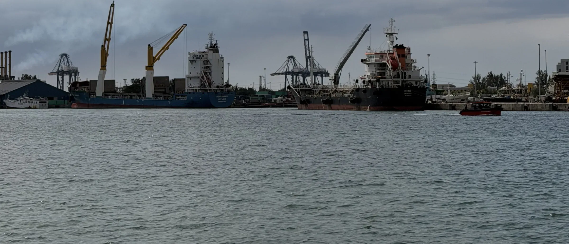 Cargo vessels and cranes at the port of Toamasina, Madagascar.
